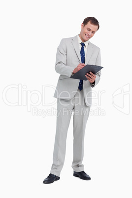 Smiling businessman taking notes