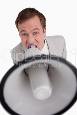 Businessman shouting through megaphone