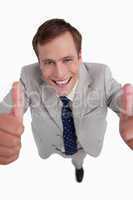 Close up of smiling businessman giving thumbs up