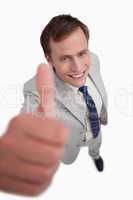 Close up of smiling businessman giving thumb up