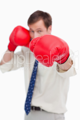 Attacking businessman with boxing gloves