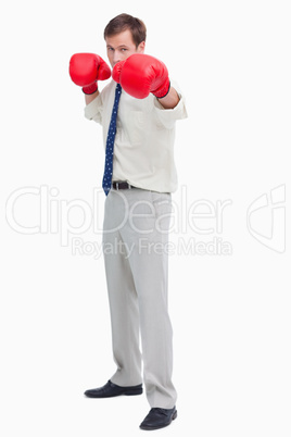 Businessman with boxing gloves in offensive position
