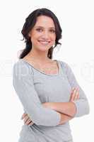 Close up of smiling young woman with her arms folded