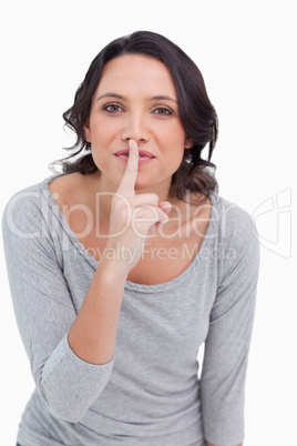 Close up of young woman asking for silence