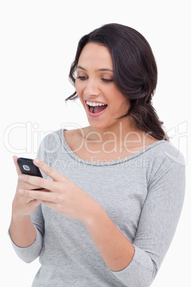 Close up of happy woman reading text message