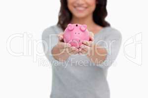 Piggy bank being held by woman