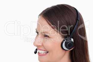 Close up side view of smiling female call center agent