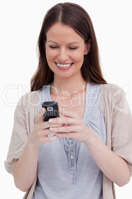 Close up of smiling woman looking at her cellphone