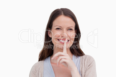 Close up of smiling woman asking for silence