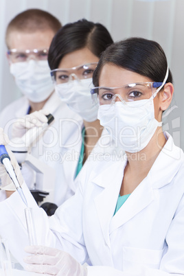 Team of Scientists With Test Tubes In Laboratory