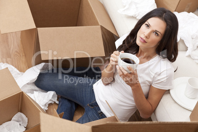 Woman Drinking Coffee Unpacking Boxes Moving House