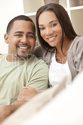 Happy African American Couple Sitting At Home