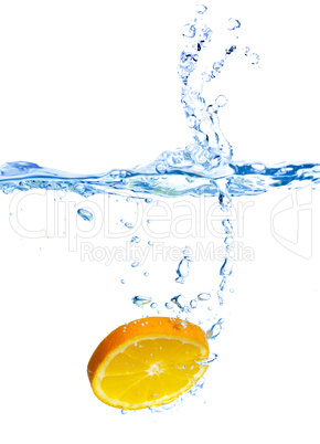 Fresh orange dropped into water with splash