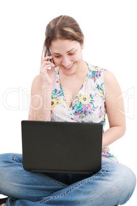 A pretty young woman sitting on floor with laptop and mobile pho