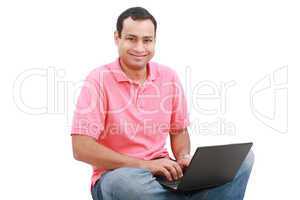 Man sitting on the floor with a laptop - isolated over a white b
