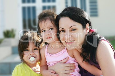 Mother and Daughters portrait outdoors in front of their home