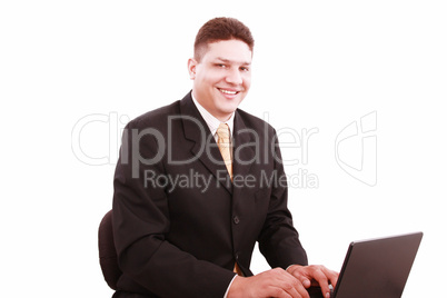 Portrait of businessman in front of laptop computer