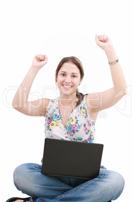 woman with laptop sitting on the floor and celebrating her succe