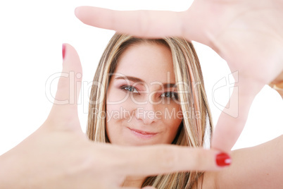 Young attractive woman framing her hands, clear vision, isolated