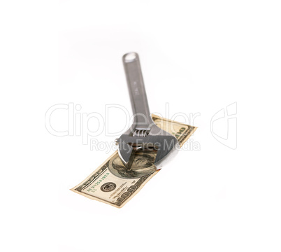 wrench and dollar bill isolated on white