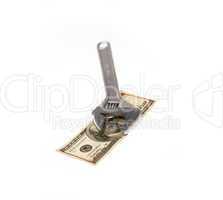 wrench and dollar bill isolated on white
