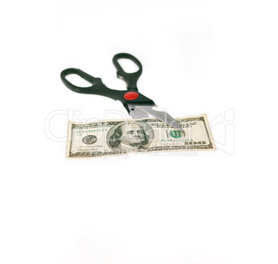scissors cutting US dollar bill  isolated on white