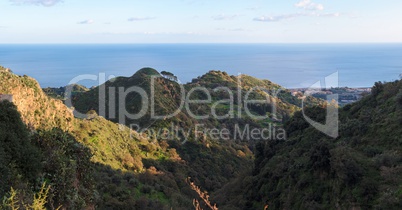 Mediterranean hills near the sea coast at sunset