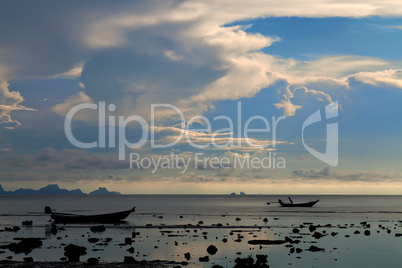 Two boat silhouettes at sunset