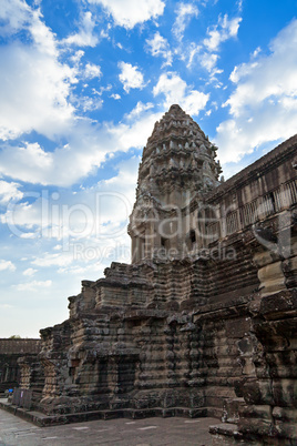 Tower in Angkor Wat temple with blue sky and clouds