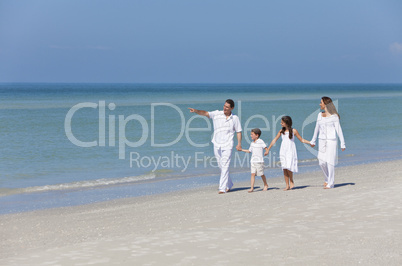 Mother, Father and Children Family Walking on Beach