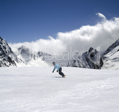 Snowboarder descends a slope