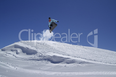 Snowboarder jumping in terrain park