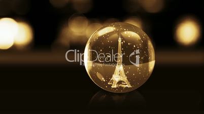 Eiffel Tower in golden glass ball with snow