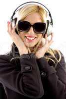 front view of smiling woman listening music