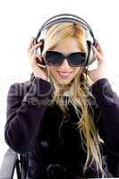 front view of smiling woman listening music