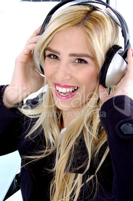 side view of smiling woman listening music