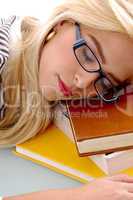 close view of female sleeping on books