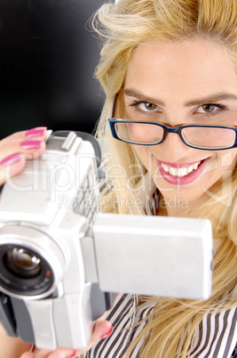 side pose of female holding video camera