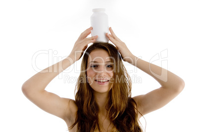 woman balancing plastic bottle on her head