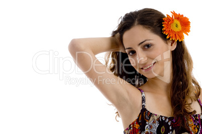 attractive young female posing with flower in hair