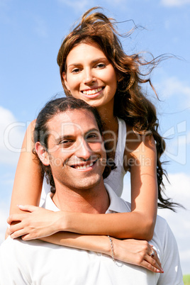 Pretty lady with arms around her man