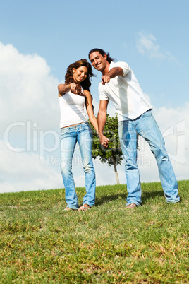 Couple pointing at camera