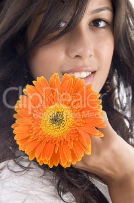 close up of beautiful model with orange gerbera