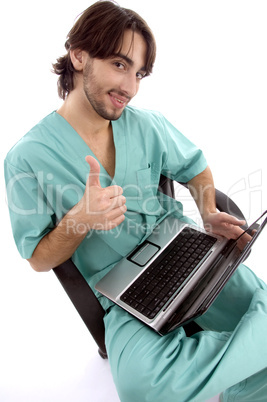 doctor working on laptop wishing goodluck
