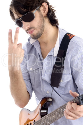 young guy holding guitar and gesturing