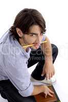 student holding pencil in mouth