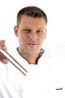 handsome chef holding chopsticks