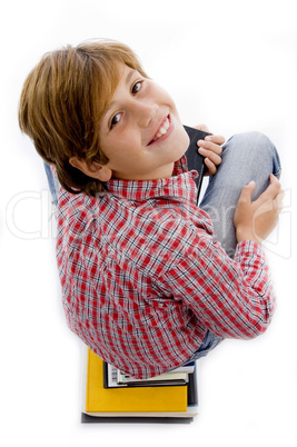 top view of boy with pile of books