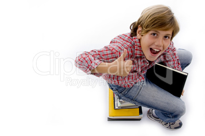 top view of boy sitting on pile of books