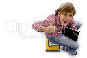 top view of boy sitting on pile of books